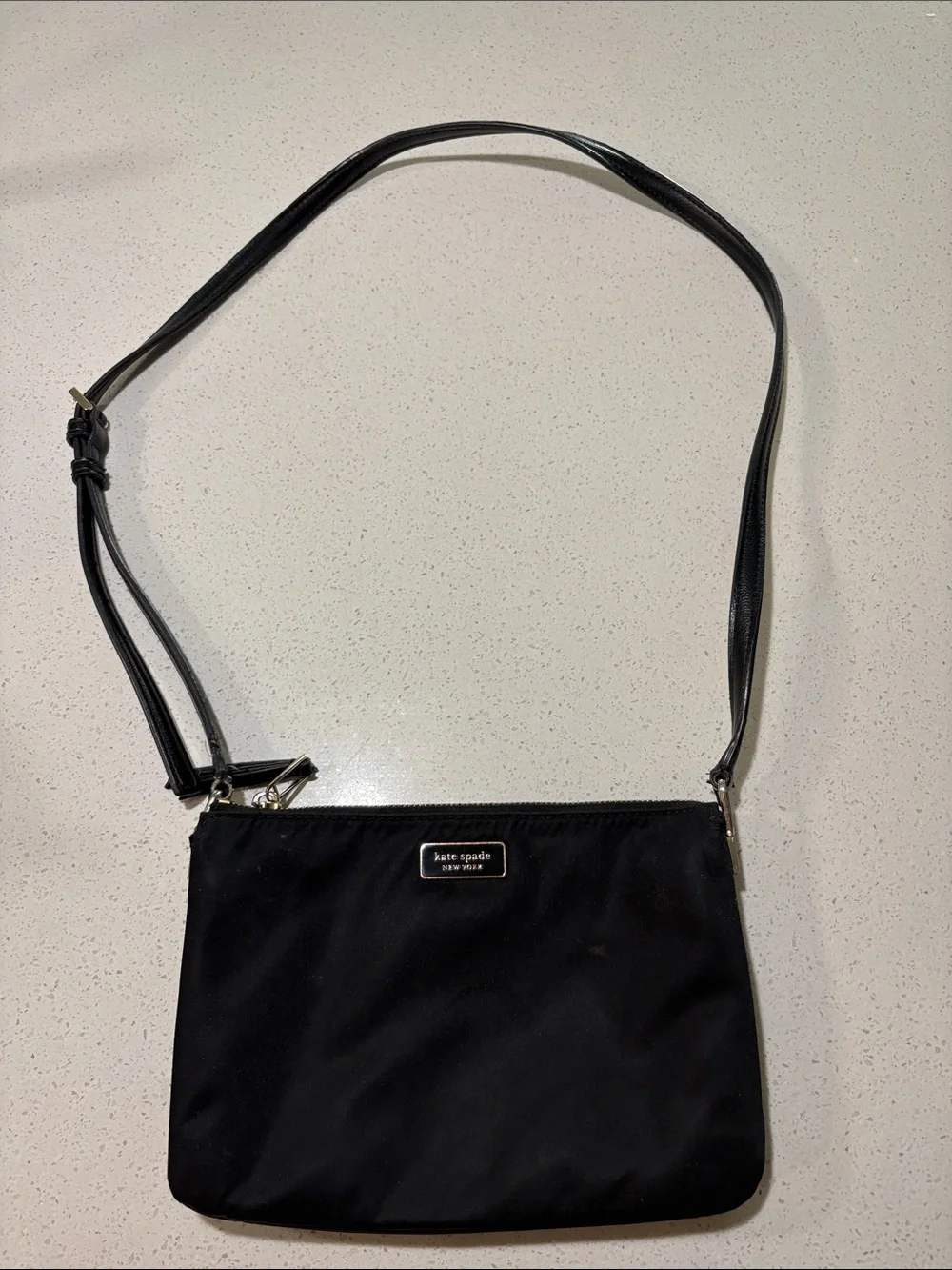 kate spade black crossbody pouch with gold-tone logo
